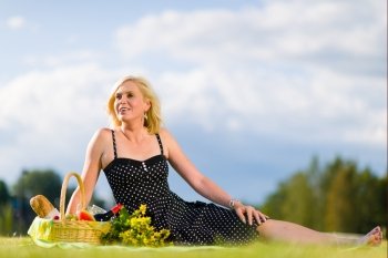 Happy woman enjoying the beautiful weather at the picnic