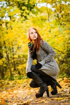 Girl with a high heels on the park, colors of autumn