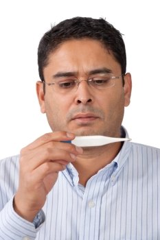 Photo of a middle-aged man looking at thermometer with worry.