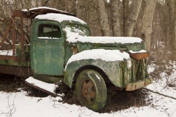 An old truck, abandoned on a side road for years, has been sitting quietly and rusting.