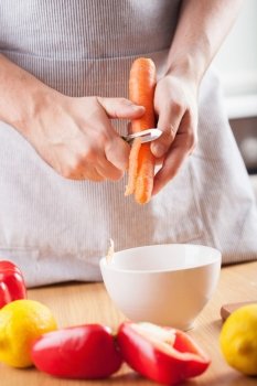 man hands peeling carrot