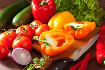 chopping healthy vegetables pepper tomato salad onion chili on rustic background