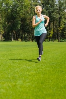 An active beautiful caucasian woman running outdoor in a park