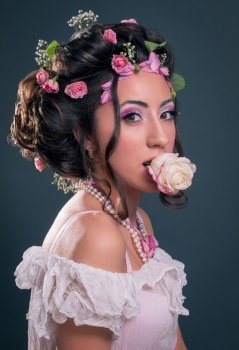 Young girl with creative hairstyle with flowers