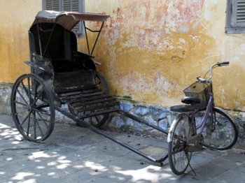 Bicycle and riksha near the wall in Hoian, Vietnam