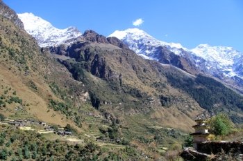 Dagoba and village in mountain in Nepal
