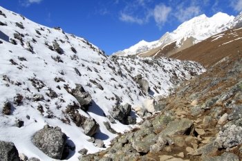Snow near footpath to Larke pass in Nepal mountain