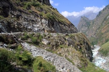 Mountain river and rocky road on the Annapurna trail in Nepal