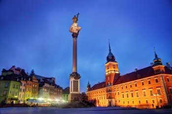 Old town in Warsaw, Poland at night. The Royal Castle and Sigismund's Column called Kolumna Zygmunta