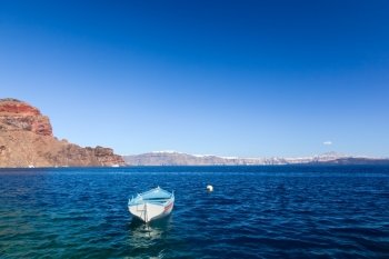 Blue and white boat on the Aegean sea. Therasia island near Santorini, Greece. 