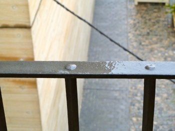 wet black railings after some rain