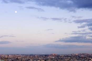 Dusk settling in over Paris, seen from Mont Martre. The last rays of sunlight striking the buildings of Paris