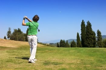 Golf Player hits his ball on the fairway 