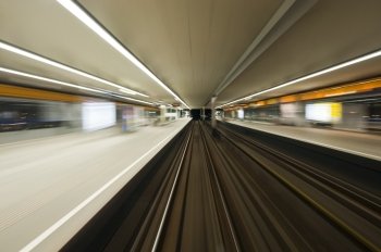Subway train, driving at speed past a station