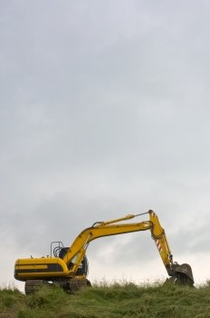 A digger on a dyke in Zeeland, the Netherlands, used to reenforce the protection against the sea