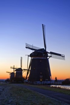 The three monumental windmills at Leidschendam, the Netherlands, neatly aligned on a beautiful winter dawn