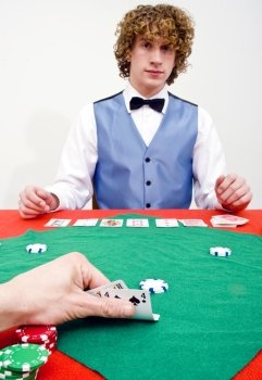 A poker player peeking at his cards during a casino game