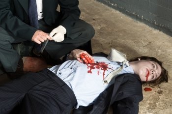 Police inspector hovering over a murdered businessman