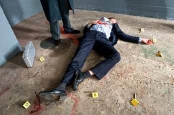 Businessman lying on the concrete floor of a basement, being shot, surrounded by evidence placards, and a man wearing a long overcoat hovering over the body