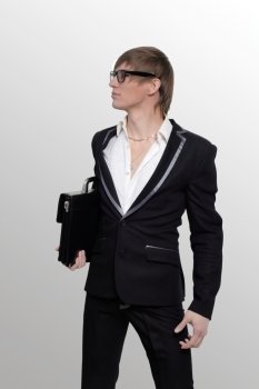 young businessman with a briefcase on white gray background
