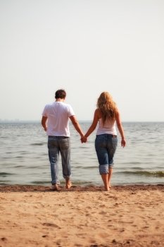 young couple walking on a beach