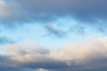 blue afternoon sky in break of harsh winter clouds
