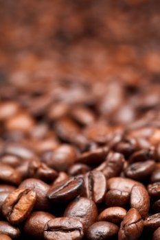 light roasted coffee beans background with focus foreground