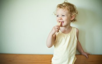 Little girl eating a cookie