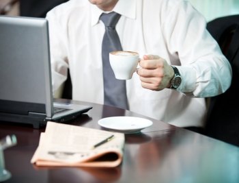 Businessman with a cup of coffee, close-up