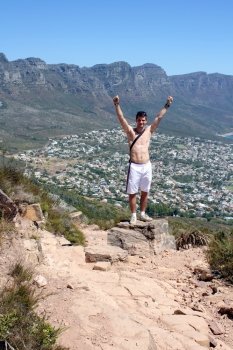 Man celebrating on lions head, cape town, south africa