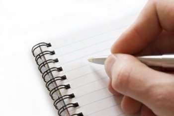 Close-up of male hand with pen ready for writing