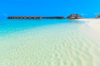 beach with water bungalows at Maldives

