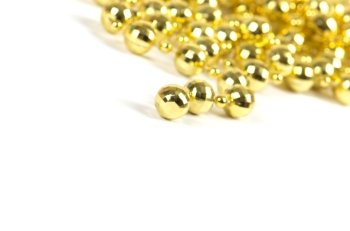 Background made of a brilliant celebratory beads of golden color over white