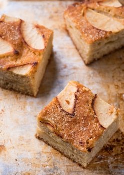 Homemade apple cake, traybake, slices on metal background, closeup, selective focus, top view