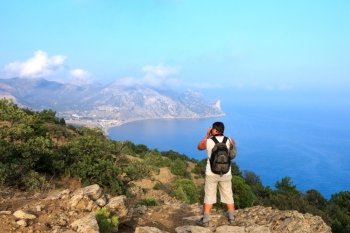 Photographer-traveler photographs the beautiful sea  Crimean landscape from the top of the mountain, Karaul-Oba, Sudak, Crimea, Ukraine
