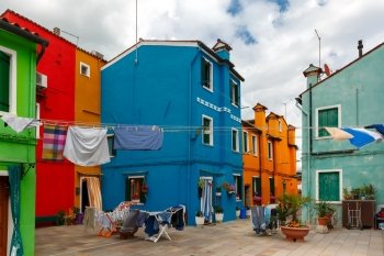 Patio with colorful houses and drying clothes on the famous island Burano, Venice, Italy