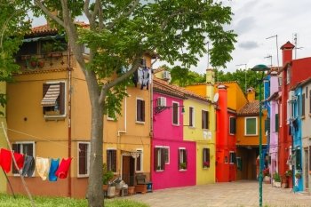 Patio with colorful houses on the famous island Burano, Venice, Italy