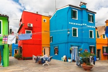 Patio with colorful houses and drying clothes on the famous island Burano, Venice, Italy