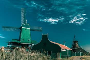 Picturesque rural landscape with windmills in Zaanse Schans, Holland, Netherlands. Toning in cool tones