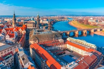 Aerial view over river Elbe with Augustus Bridge, Hofkirche, Royal Palace and roofs of old Dresden, Saxony, Germany