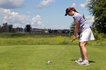 Woman golfer with a golf club on the tee box