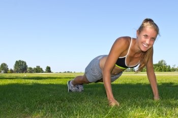 Fit, athletic woman doing push ups