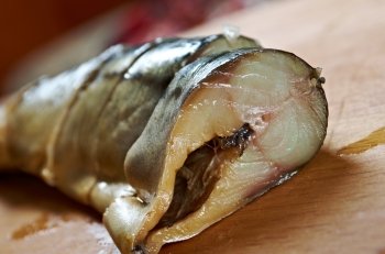 Smoked mackerel cut with slices . Shallow depth-of-field.