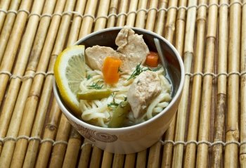 chinese noodle with chicken and vegetables on wood table