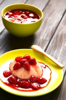 Semolina pudding with strawberry compote served on plate, photographed with natural light (Selective Focus, Focus on the front of the semolina pudding)