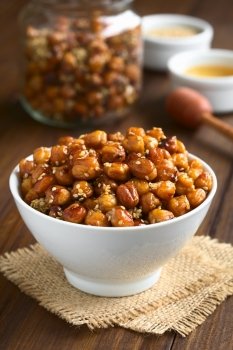 Chickpeas roasted with sesame and honey, photographed with natural light (Selective Focus, Focus one third into the chickpeas)