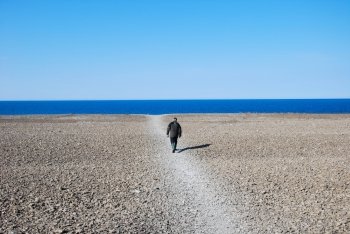 A man going to the beach at the swedish island Oland in springtime