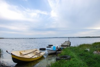 Moored rowing boats by the coast of Baltic Sea at the island Oland in Sweden.