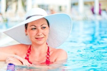 young woman relaxing in the pool at the resort