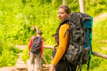 young couple in summer hike with backpacks